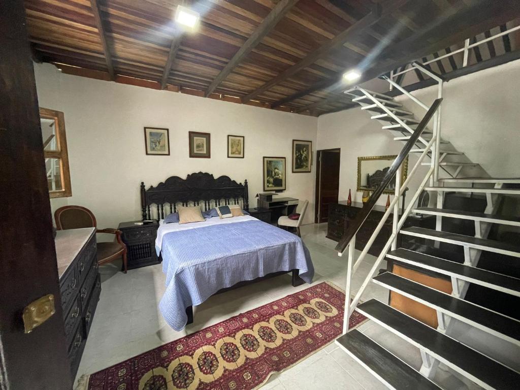 a bedroom with a bed and a spiral staircase at Amazon Lodge Varillal in Iquitos