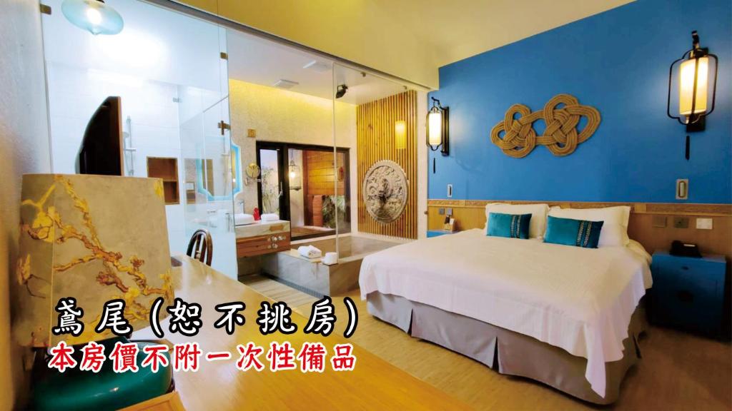 a bedroom with a large bed and a bathroom at Tingtau Villa in Lugu Lake