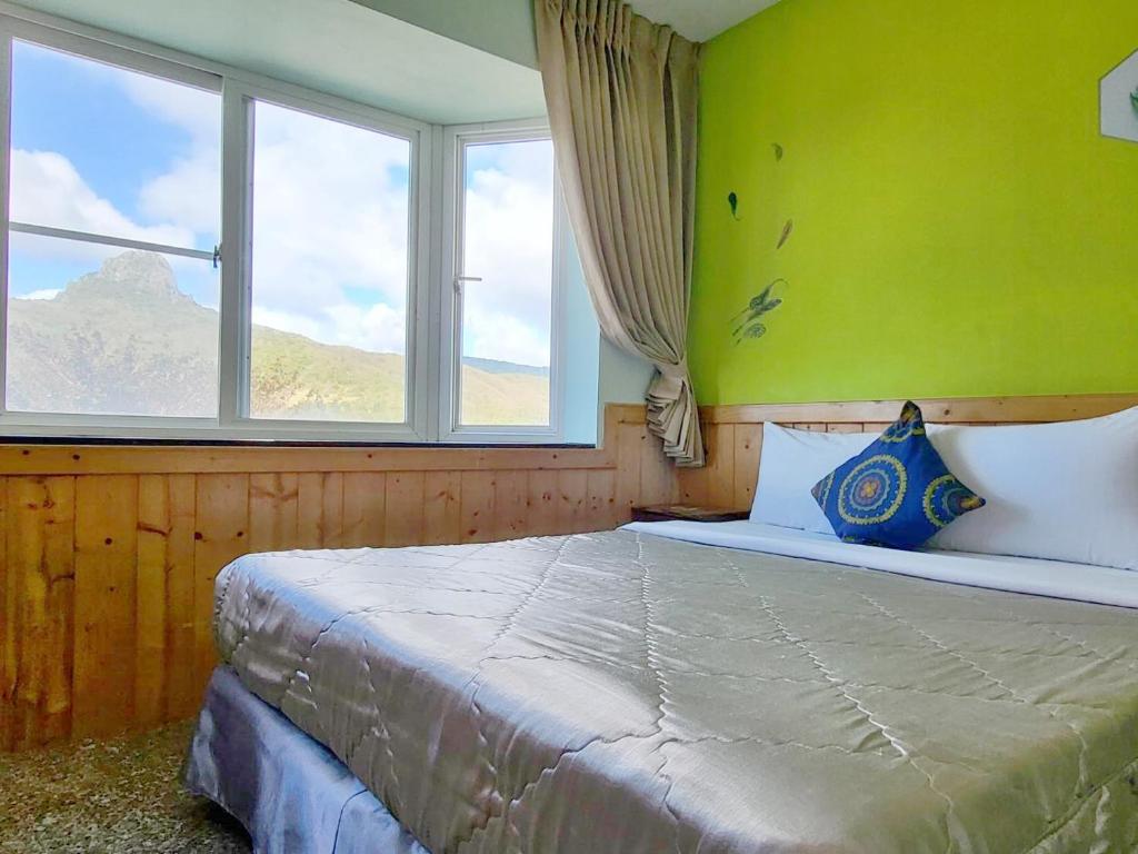 Postel nebo postele na pokoji v ubytování Xing Ji Hotel