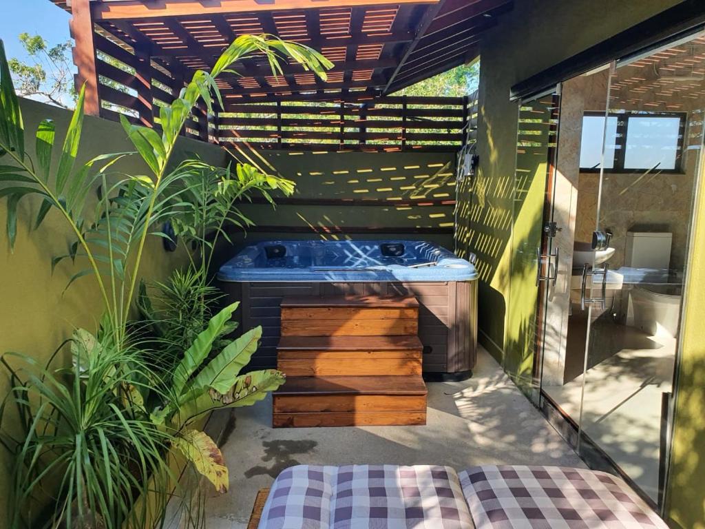 a bathroom with a tub and some plants at Allure Yala - Lakeside Luxury Suites in Yala