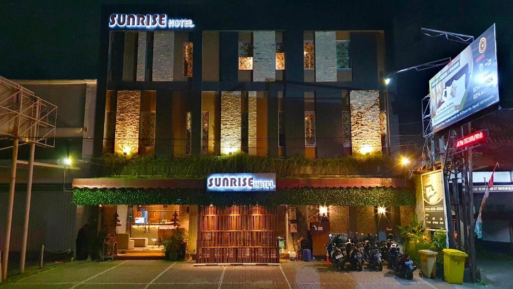 a building with a sign that reads sunrise on it at Sunrise Hotel Jogja in Yogyakarta