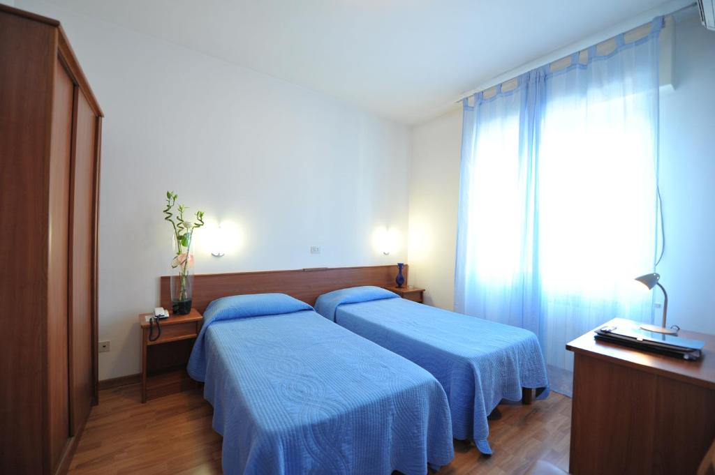 Postel nebo postele na pokoji v ubytování Hotel Astor