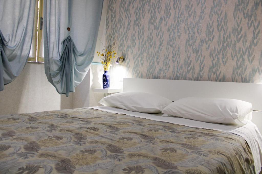 a bedroom with a large bed with white pillows at Eufonia Vatican Days in Rome