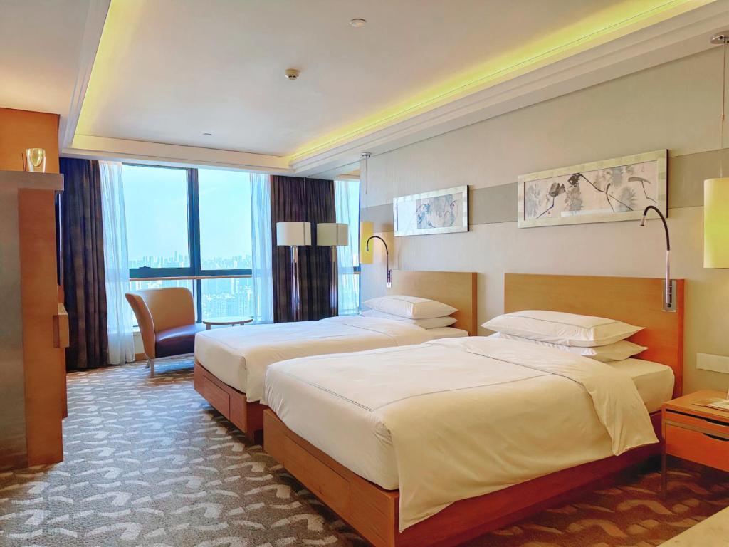 Postel nebo postele na pokoji v ubytování Swissotel Foshan, Guangdong - Free shuttle to Canton Fair