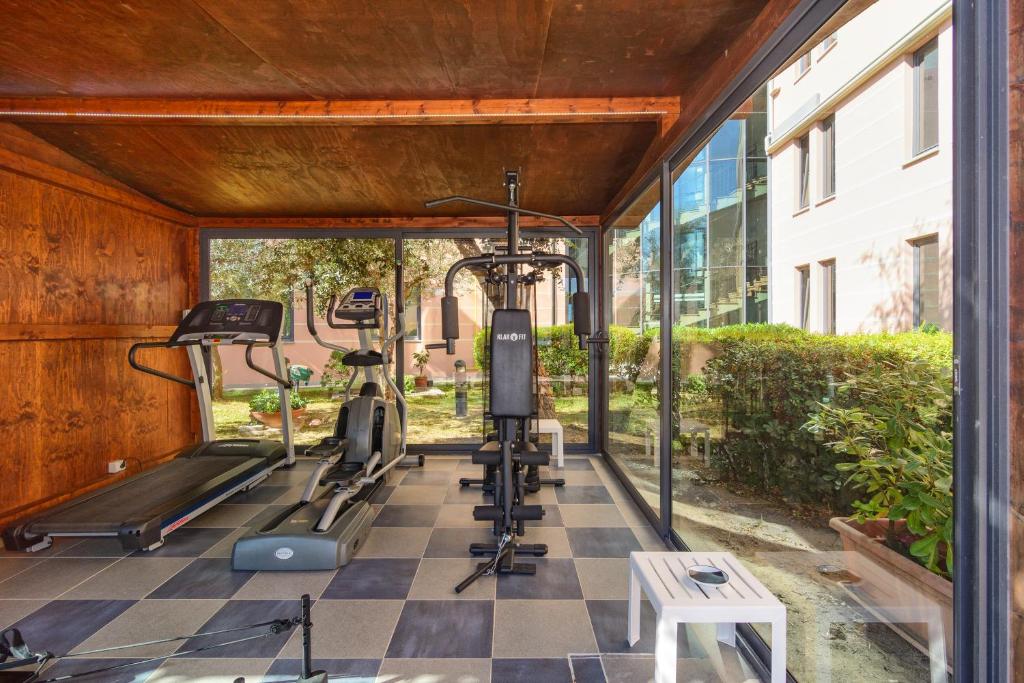 a gym with a checkered floor and tread machines at L'incanto Di Boccadarno in Marina di Pisa
