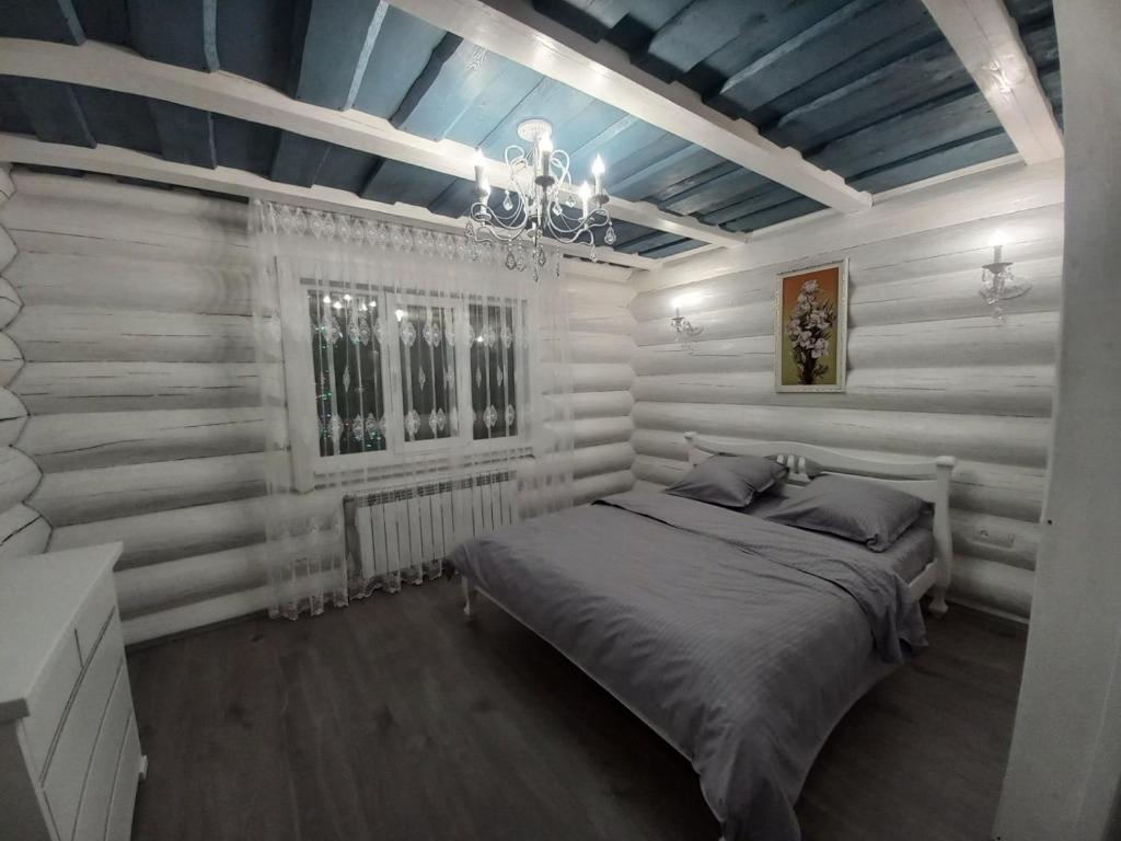 a bedroom with white walls and a bed in it at White House in Synevyrsʼka Polyana