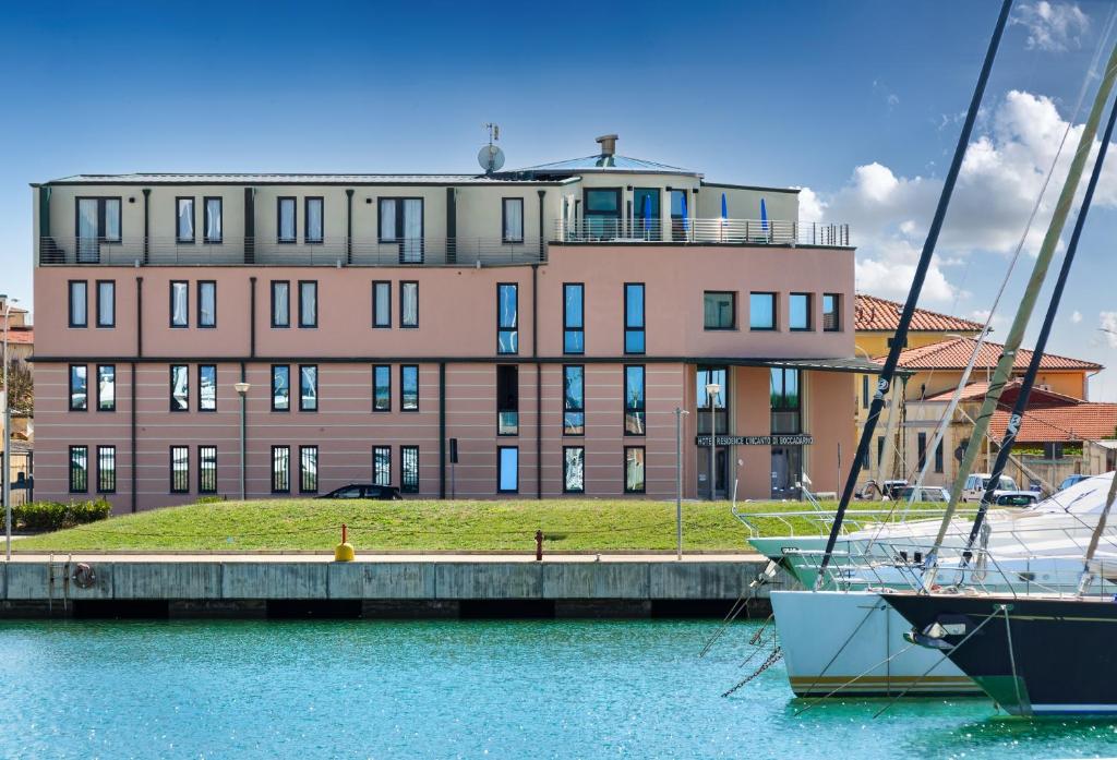two boats docked in the water in front of a building at L'incanto Di Boccadarno in Marina di Pisa