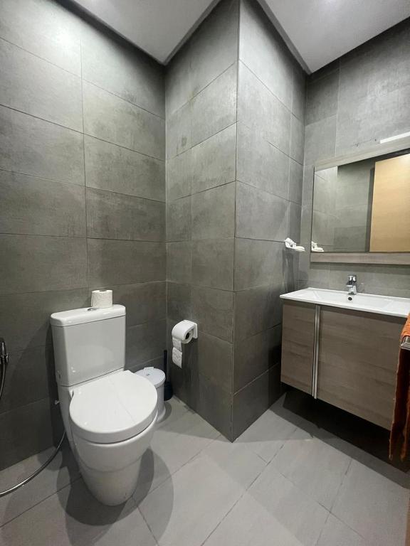 a bathroom with a toilet and a sink at Shiny appartment in Prestigia in Rabat