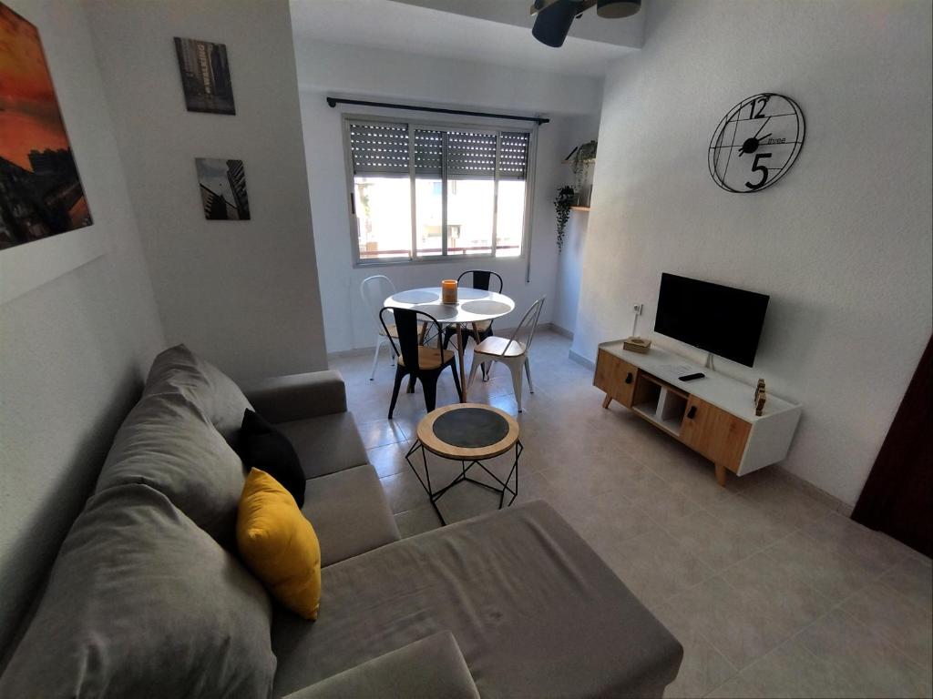 a living room with a couch and a table at ROOMS in SHARED APARTMENT with HOST in Alicante