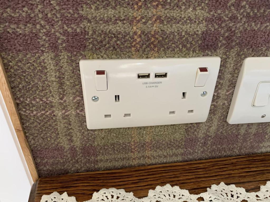 a close up of a electrical outlet on a wall at Old Drynie House, in Inverness