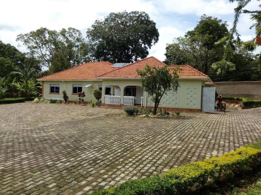 a house with a brick driveway in front of it at Talpa Residences. in Tororo
