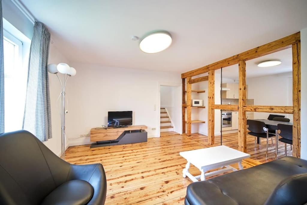 a living room with a couch and a table at Großzügige Wohnung auf dem Hof Historischen Mühle in Holzhausen