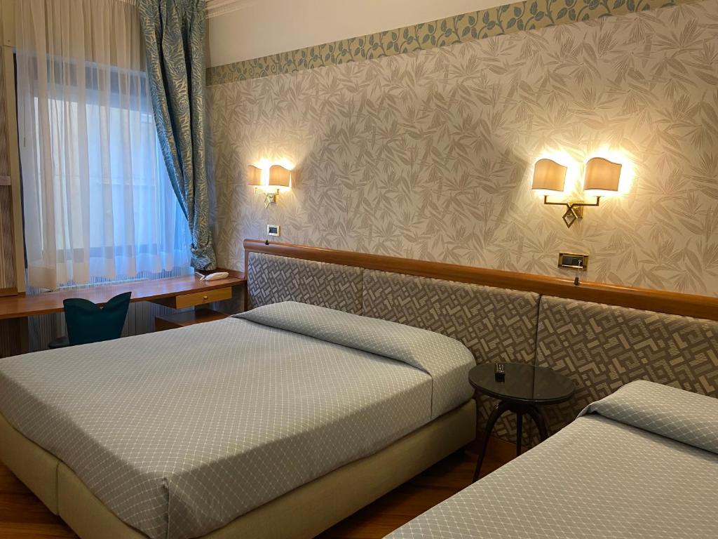 Postel nebo postele na pokoji v ubytování Hotel Europa