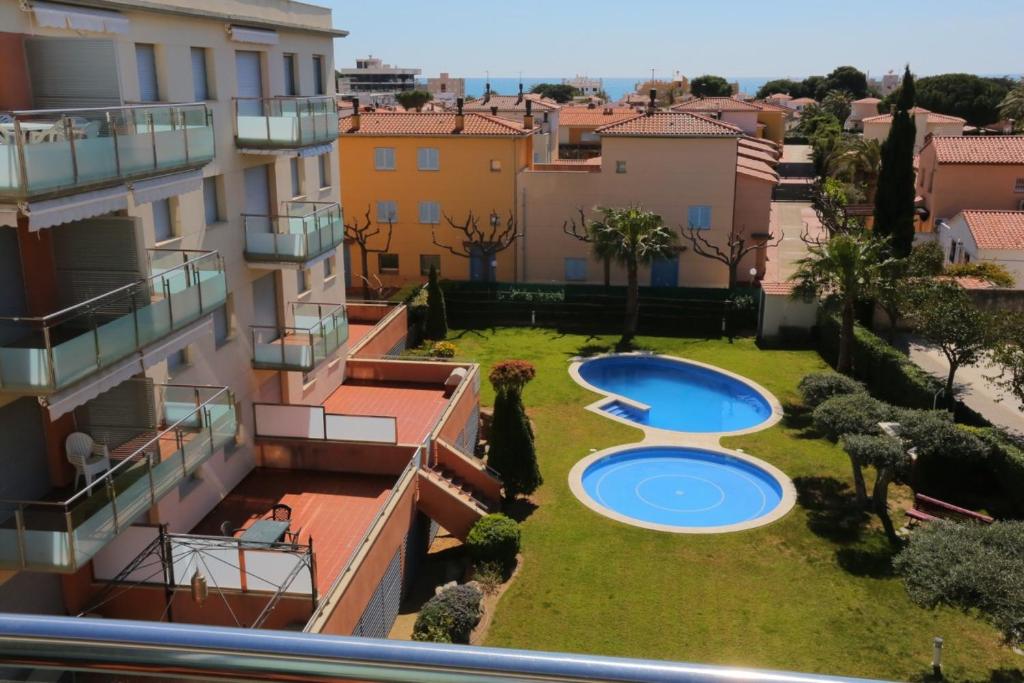 a view from a balcony of a building with two swimming pools at Sol Millet Litoral - ONLY FAMILIES in Cambrils