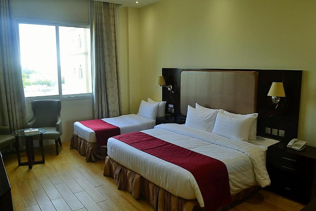 Postel nebo postele na pokoji v ubytování Palm Inn Hotel Doha