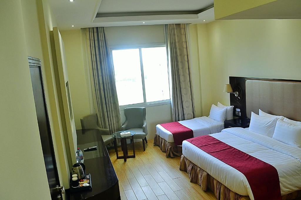 Postel nebo postele na pokoji v ubytování Palm Inn Hotel Doha