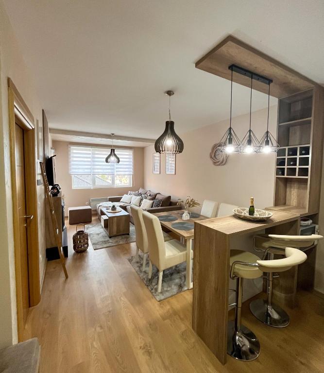 a kitchen and living room with a table and chairs at Borski Luxury Apartments in Zlatibor