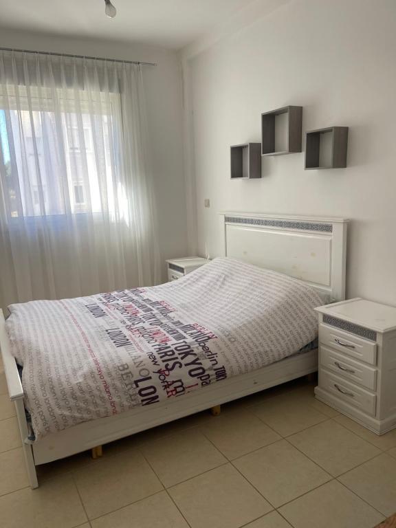 a bedroom with a bed and a dresser and a window at Love House Tanger in Tangier