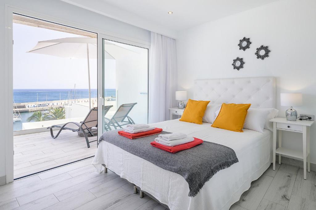 a bedroom with a bed with a view of the ocean at Casa Mercedes, Puerto del Carmen in Puerto del Carmen