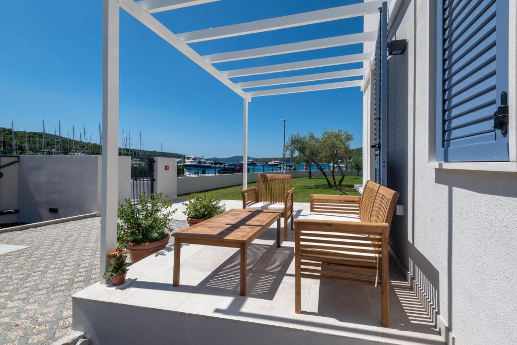 a patio with two chairs and a table on a balcony at Luxury Seaview Apartment - Sole in Slano