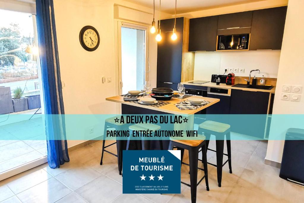 a kitchen with a counter with a sign that reads a view fees you will need at A 2 PAS DU LAC - WIFI - Garage - Netflix - Disney+ - Lac in Sévrier