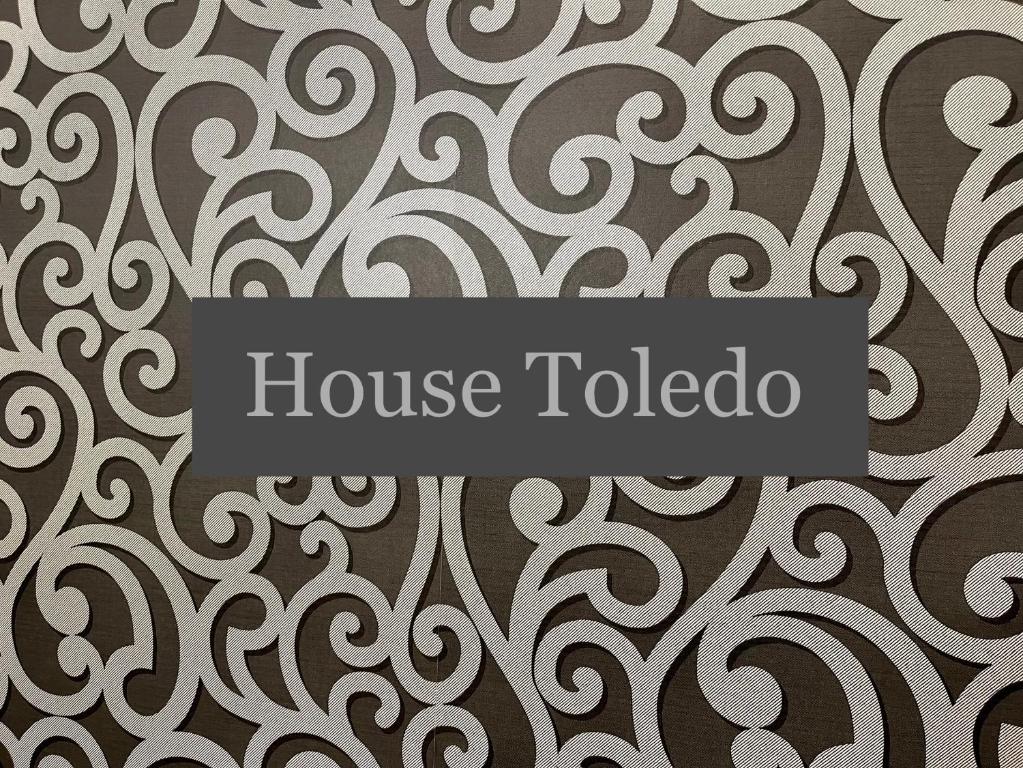 a wall with a pattern with a house toledo sign at House Toledo in Naples