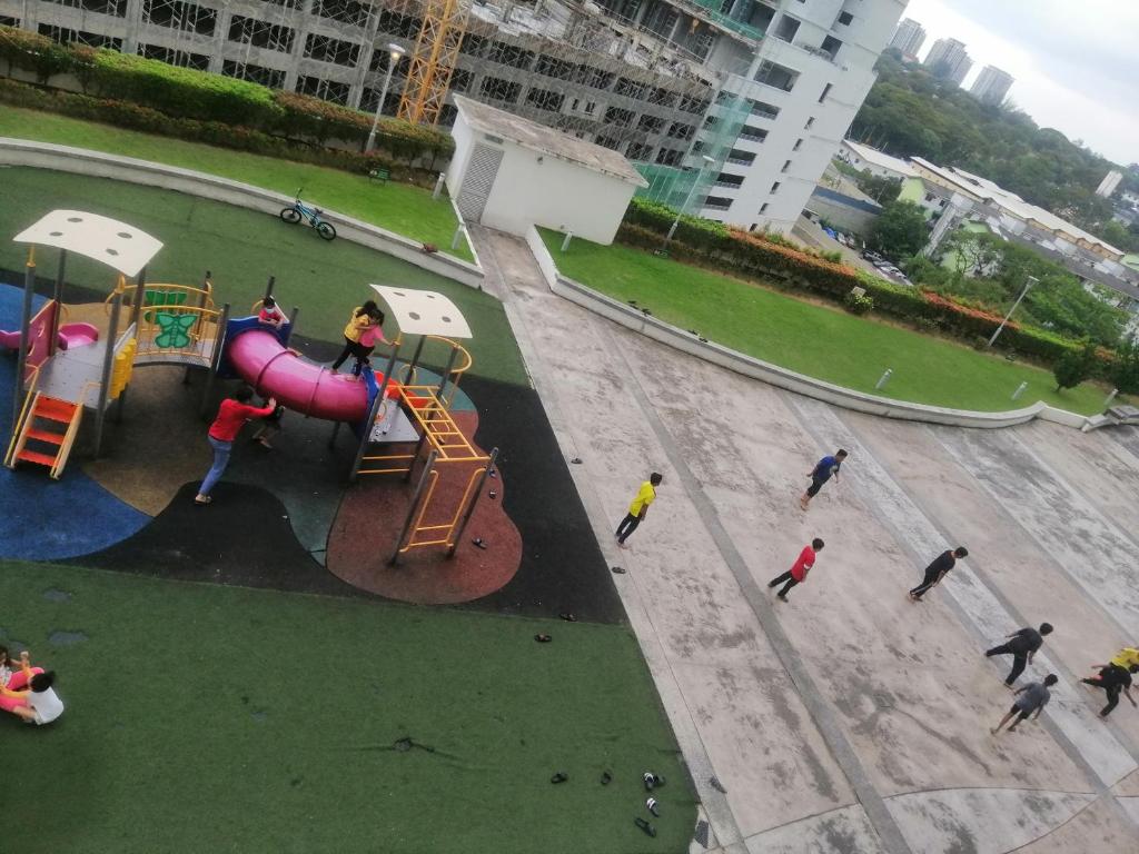 a group of people playing in a playground at Zulcity Homestay in Gelugor