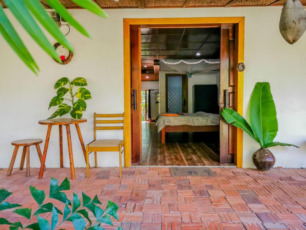 Habitación con una puerta que conduce a un dormitorio en Yi family Homestay en Siem Reap