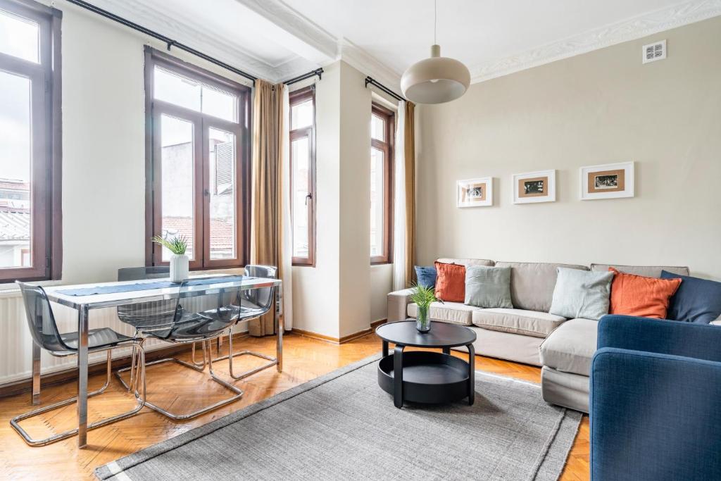 a living room with a couch and a table at Chic Taksim Flat 1 min to Istiklal Ave in Istanbul