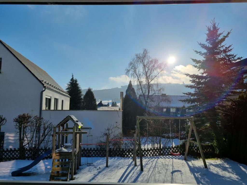 a playground in the snow with a christmas tree at Wohnung Nr. 1 Willingen in Willingen