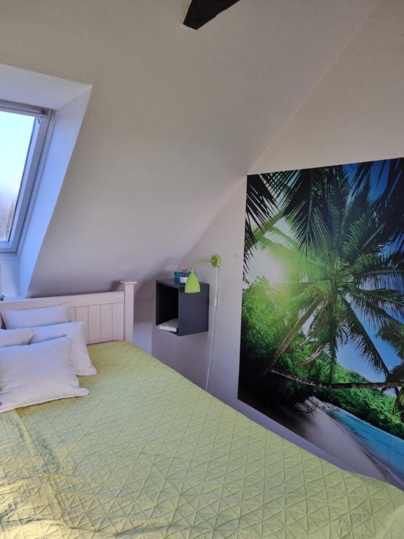 a bedroom with a palm tree mural on the wall at Marsvinslund bed and breakfast in Viborg