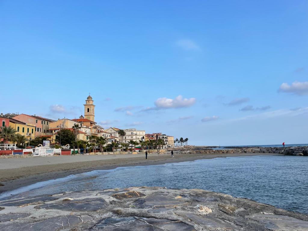 a view of a beach with a town in the background at Bistrot del mare in Santo Stefano al Mare