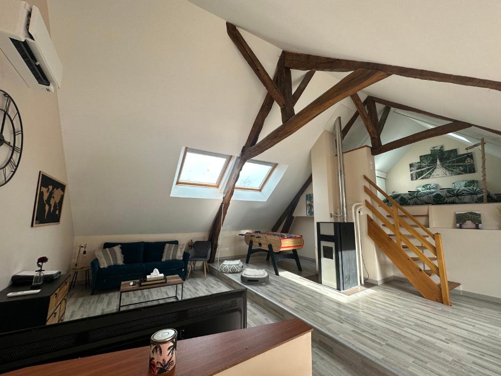 a living room with a couch and a table at La Maison du Moulin à Vent in La ForestiÃ¨re