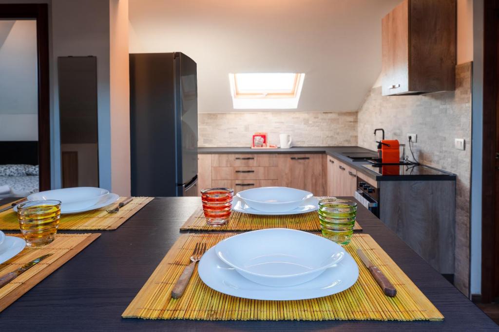 a kitchen with a table with plates on it at LA SOFFITTA DEI SOGNI 010059-LT-2481 in Sestri Levante