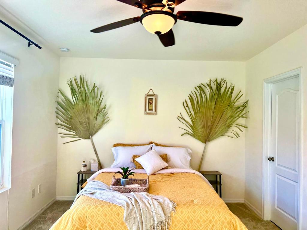 a bedroom with a bed with a ceiling fan at A Cozy Home Away From Home in Riverview