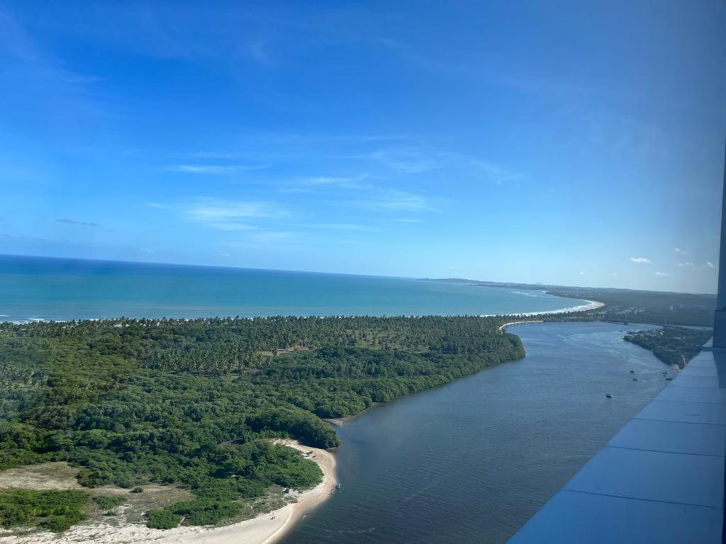 an aerial view of a river with trees and a beach at Paiva (Barra Home Stay) Luxuoso - vista incrível 26 andar in Recife