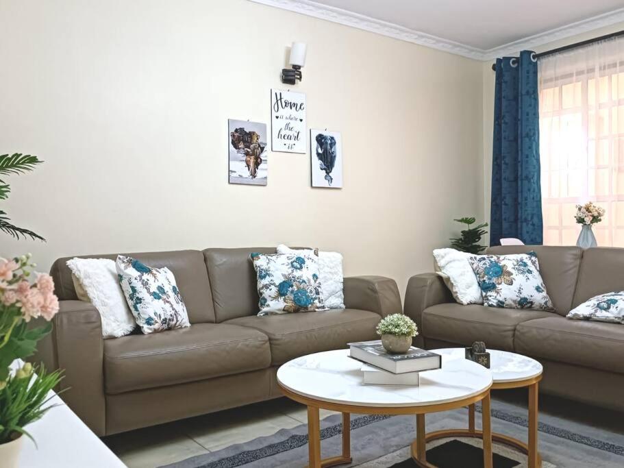 a living room with a couch and a table at Stylish 2 bedroom apartment in Nairobi