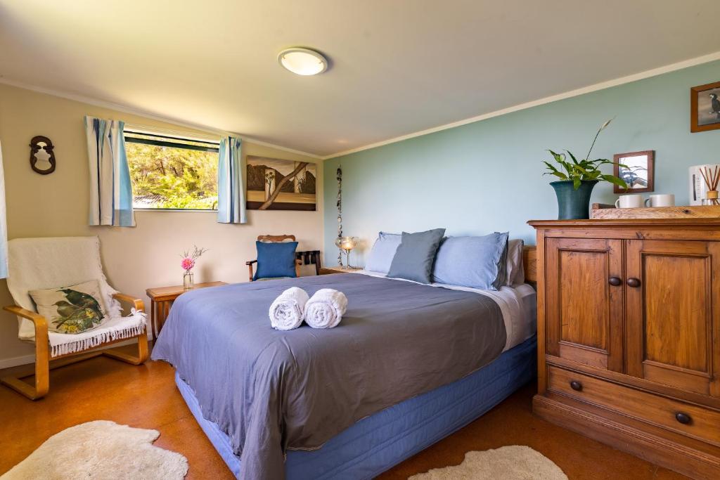 a bedroom with a bed with two pillows on it at Ao Marama Retreat in Collingwood