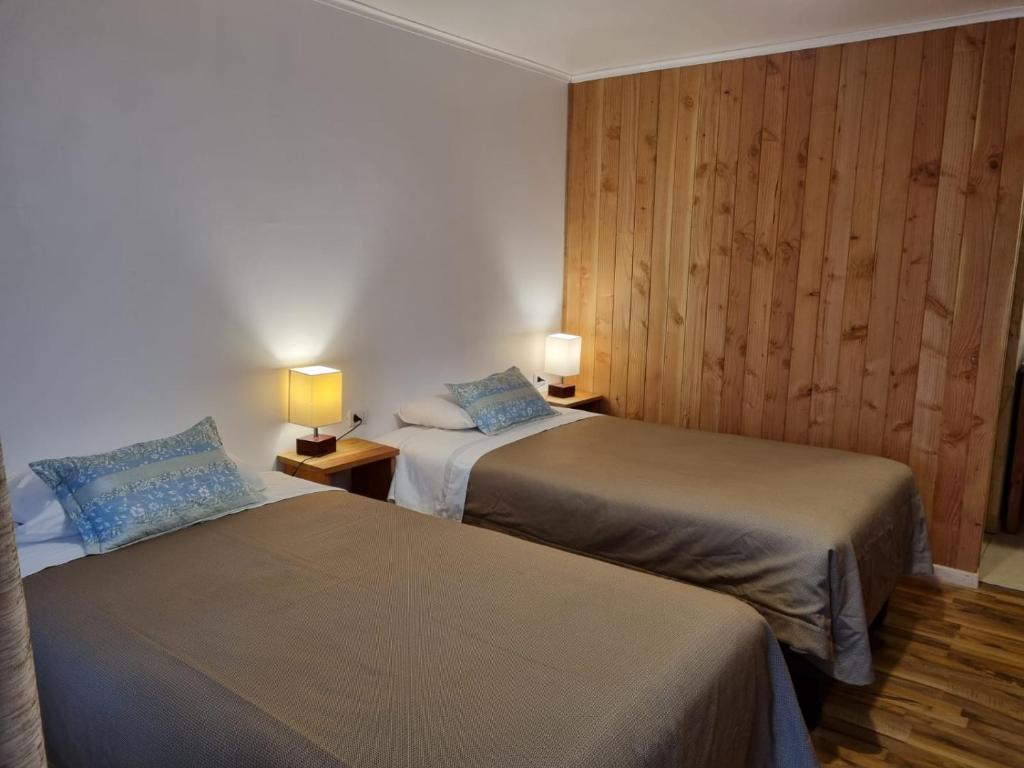Postel nebo postele na pokoji v ubytování Apart Hotel Antu de Villarrica