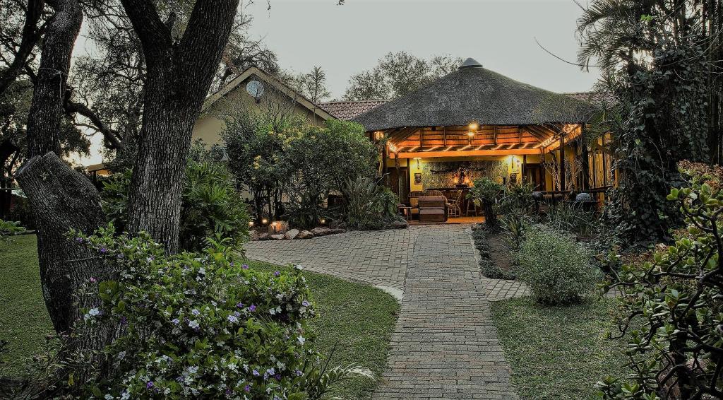 a house with a pathway leading to a house at Sunbird Lodge in Phalaborwa