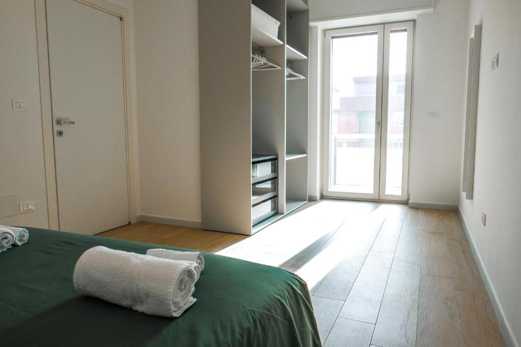 Łóżko lub łóżka w pokoju w obiekcie Rossani Suites&Aparts