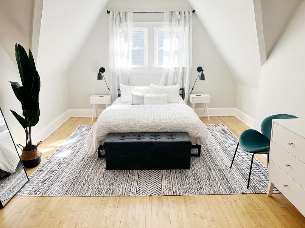 a bedroom with a bed and a large window at The Cambridge House in Milwaukee