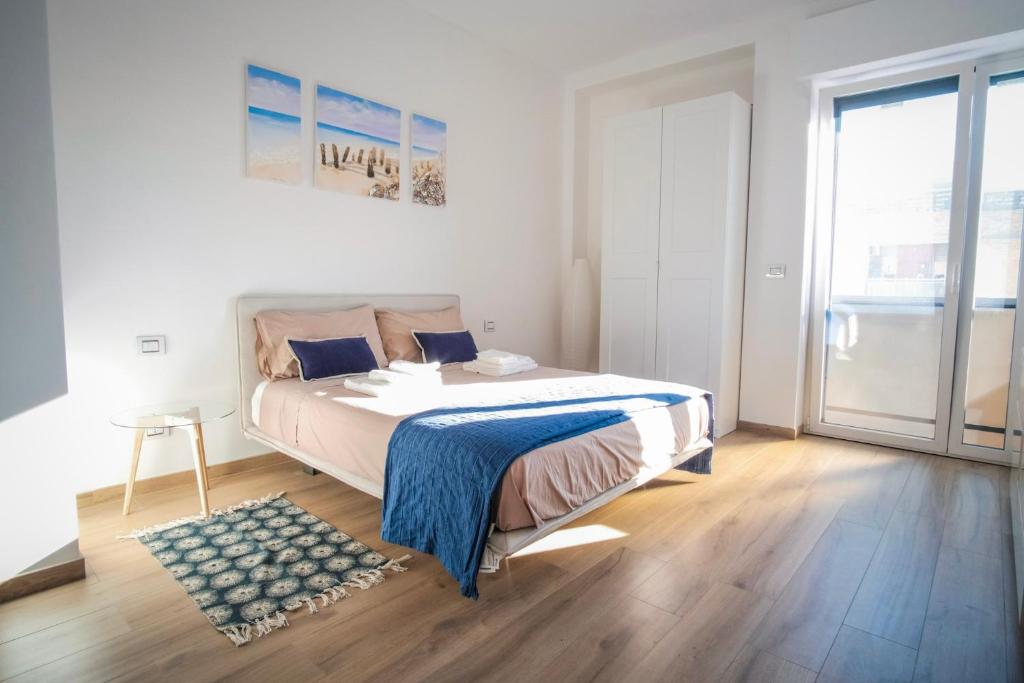 Łóżko lub łóżka w pokoju w obiekcie Rossani Suites&Aparts