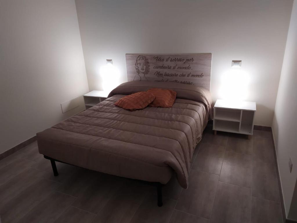 A bed or beds in a room at Dimora Sorriso