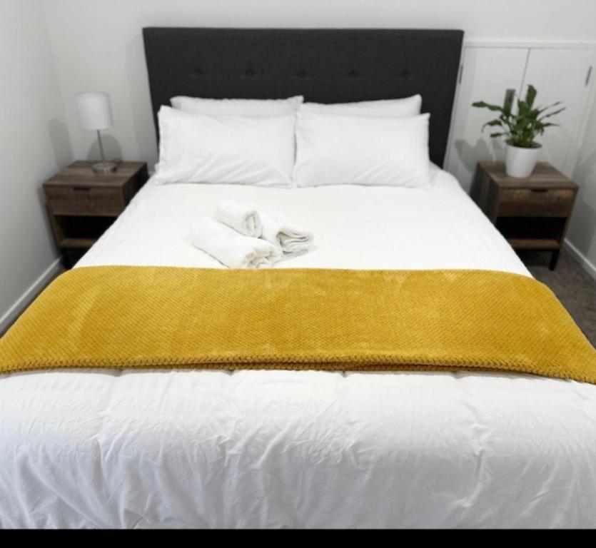 sypialnia z łóżkiem z dwoma ręcznikami w obiekcie Trafalgar Place w Auckland