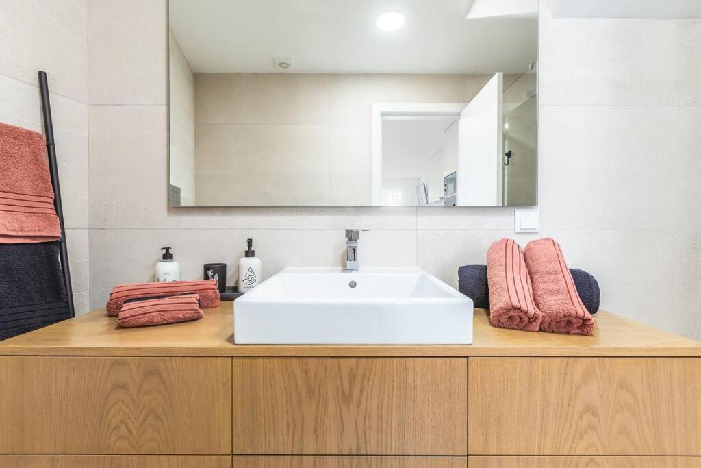 a bathroom counter with a sink and a mirror at Studio Sweet Dreams in Aveiro touristic center in Aveiro