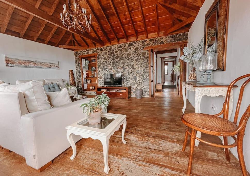 a living room with a white couch and a table at Casa La Encarnación in Santa Cruz de la Palma