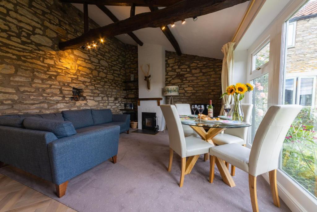 a living room with a blue couch and a table at Ryedale Cottage in Helmsley
