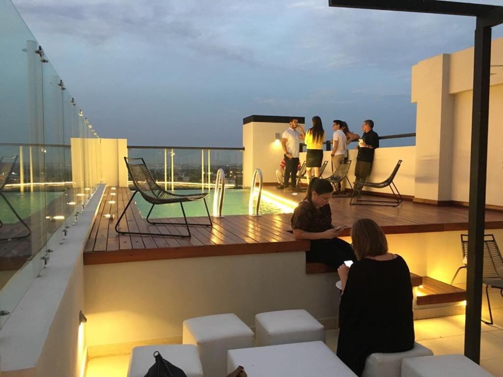 a group of people sitting on the balcony of a building at Miradores del Chaco in Asuncion