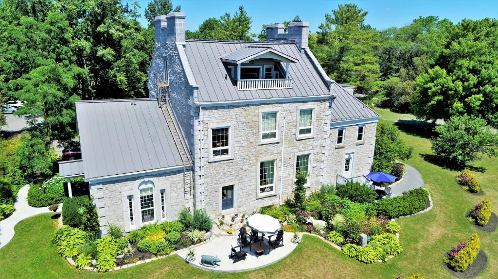 an aerial view of a large stone house at All Suites Whitney Manor in Kingston